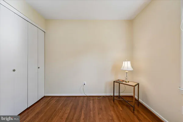 a view of a roof deck with table and chairs under an umbrella with wooden floor
