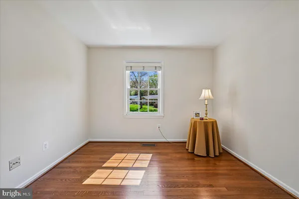 a view of a patio with table and chairs under an umbrella