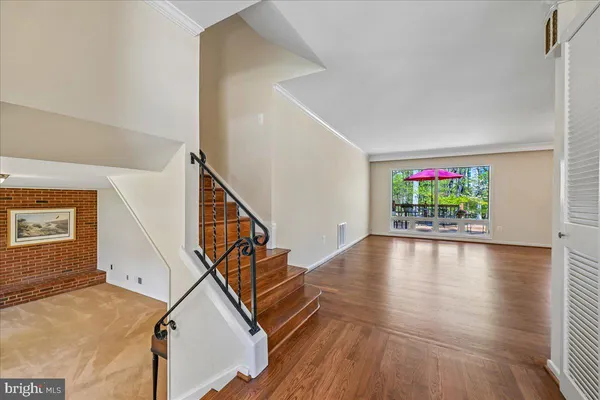 a view of an entryway with wooden floor