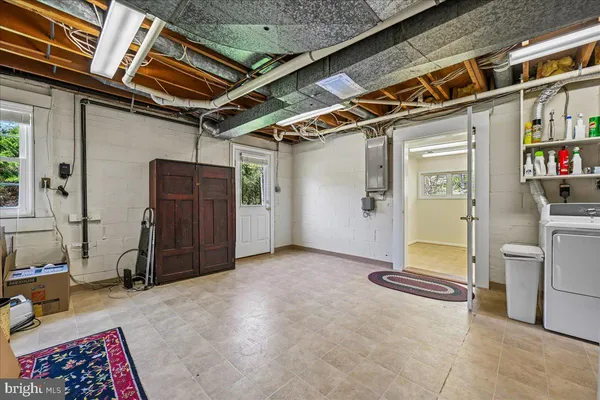 a view of a park that has a sign board large trees