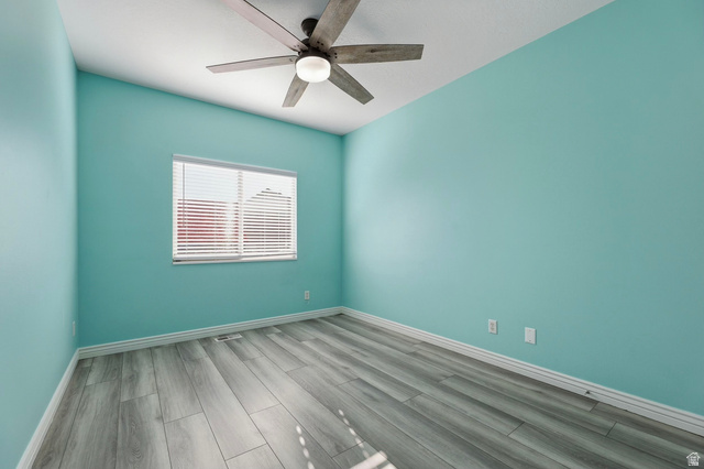 989 South Cinnamon Ridge Drive Provo, UT 84606 - Photo 22 of 52 Room featuring wood-finish flooring, a ceiling fan with light fixture, and a window with horizontal blinds