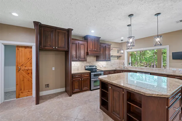 a kitchen with a stove sink and microwave