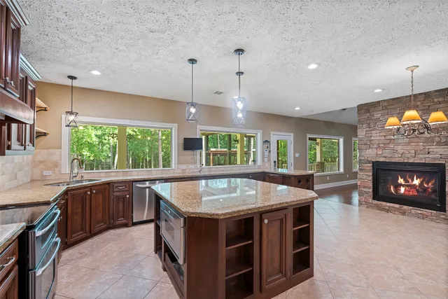 a large kitchen with a table and chairs