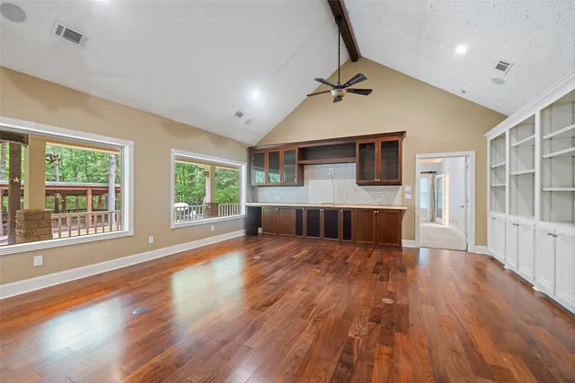 a living room with furniture a fireplace and a large window