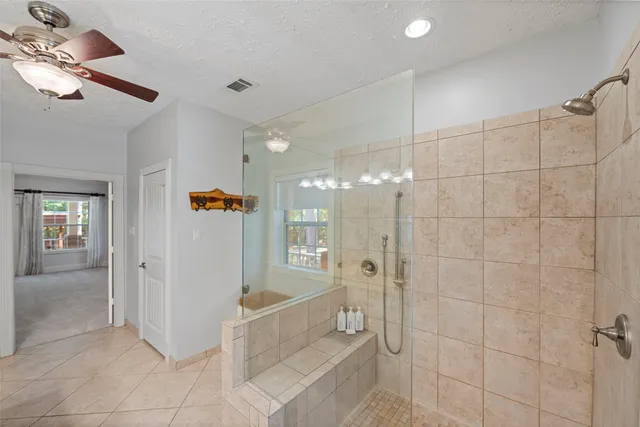 a kitchen with kitchen island a counter top space and a ceiling fan