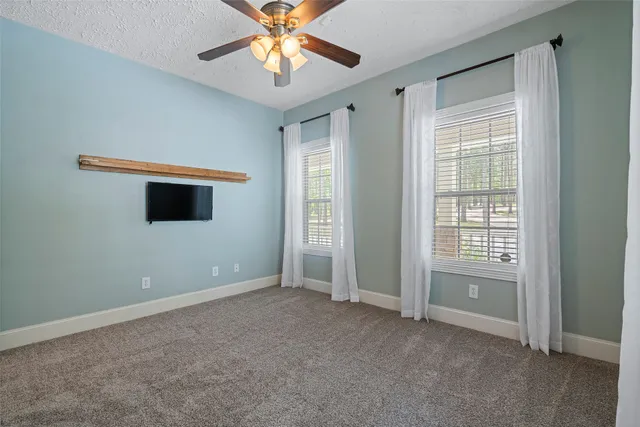 a bathroom with a granite countertop sink a mirror and a shower
