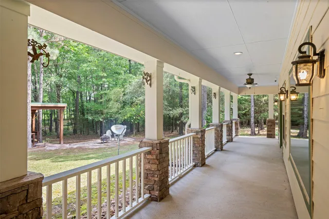 a view of a house with a wooden deck and a yard