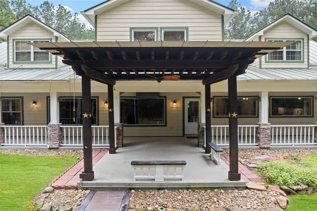 a view of a house with a yard deck and sitting area