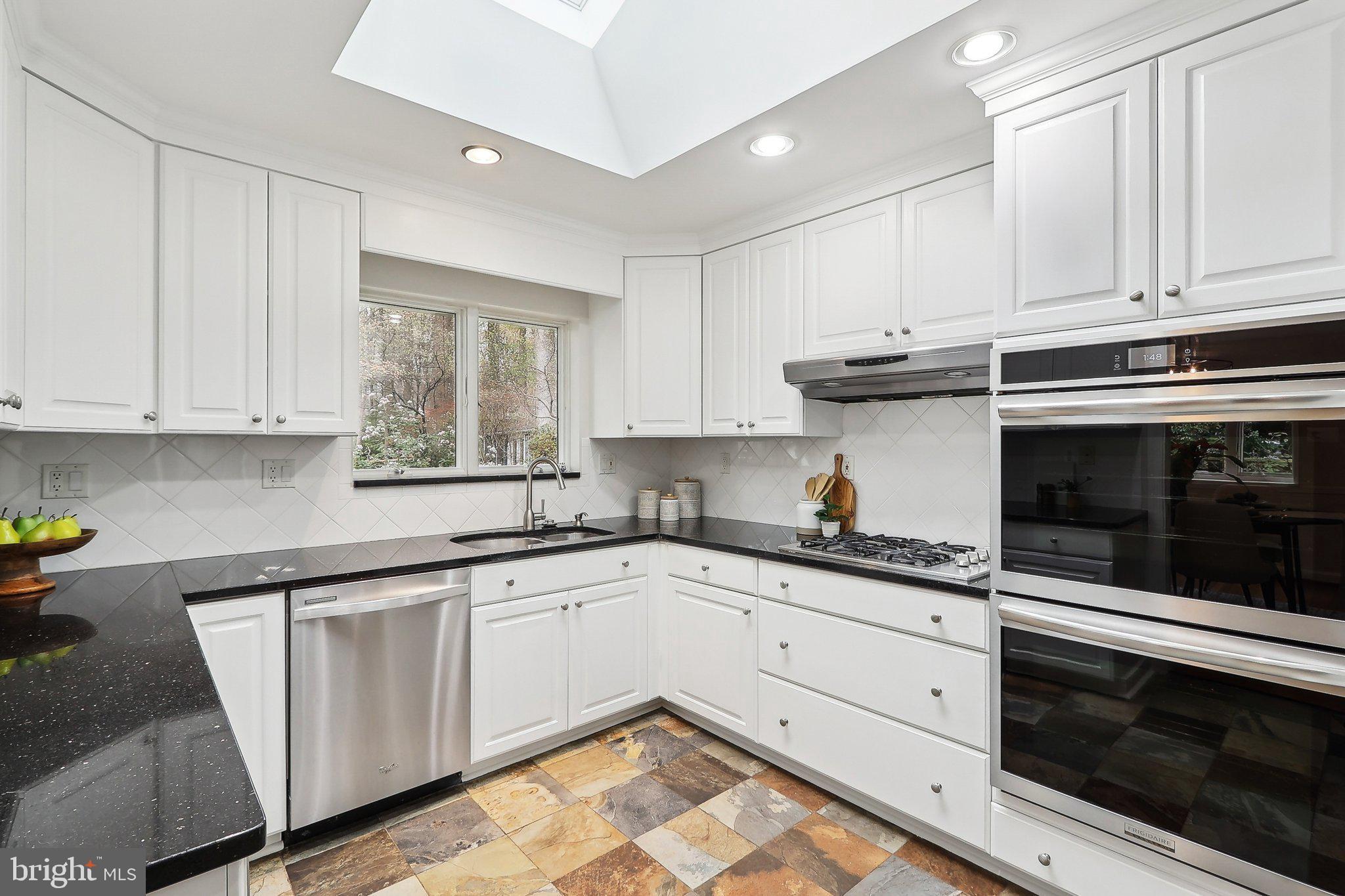 4212 Wakefield Drive Annandale, VA 22003 - Photo 16 of 67 a kitchen with granite countertop white cabinets stainless steel appliances and a sink