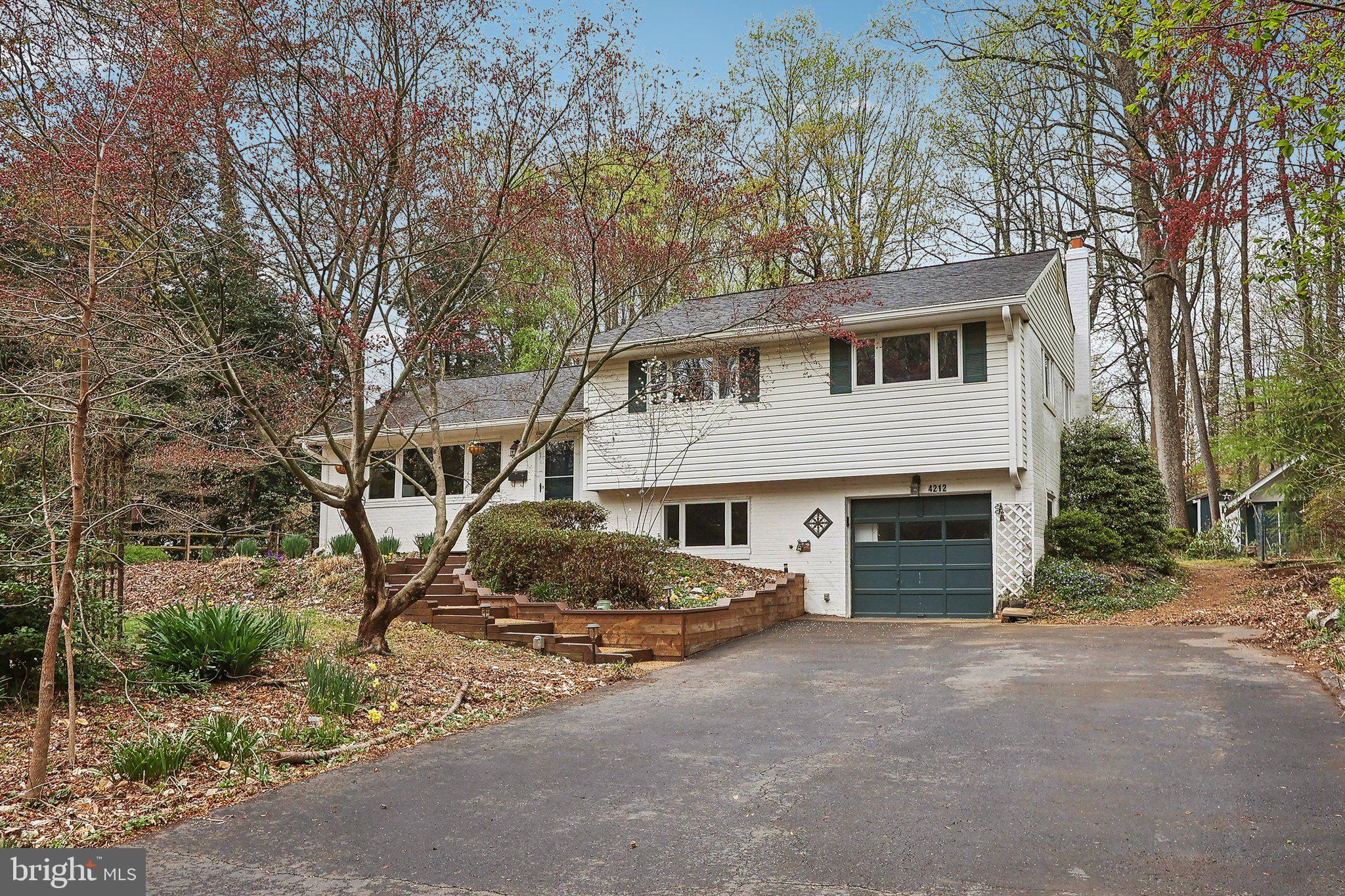 4212 Wakefield Drive Annandale, VA 22003 - Photo 66 of 67 a front view of a house with a yard and garage