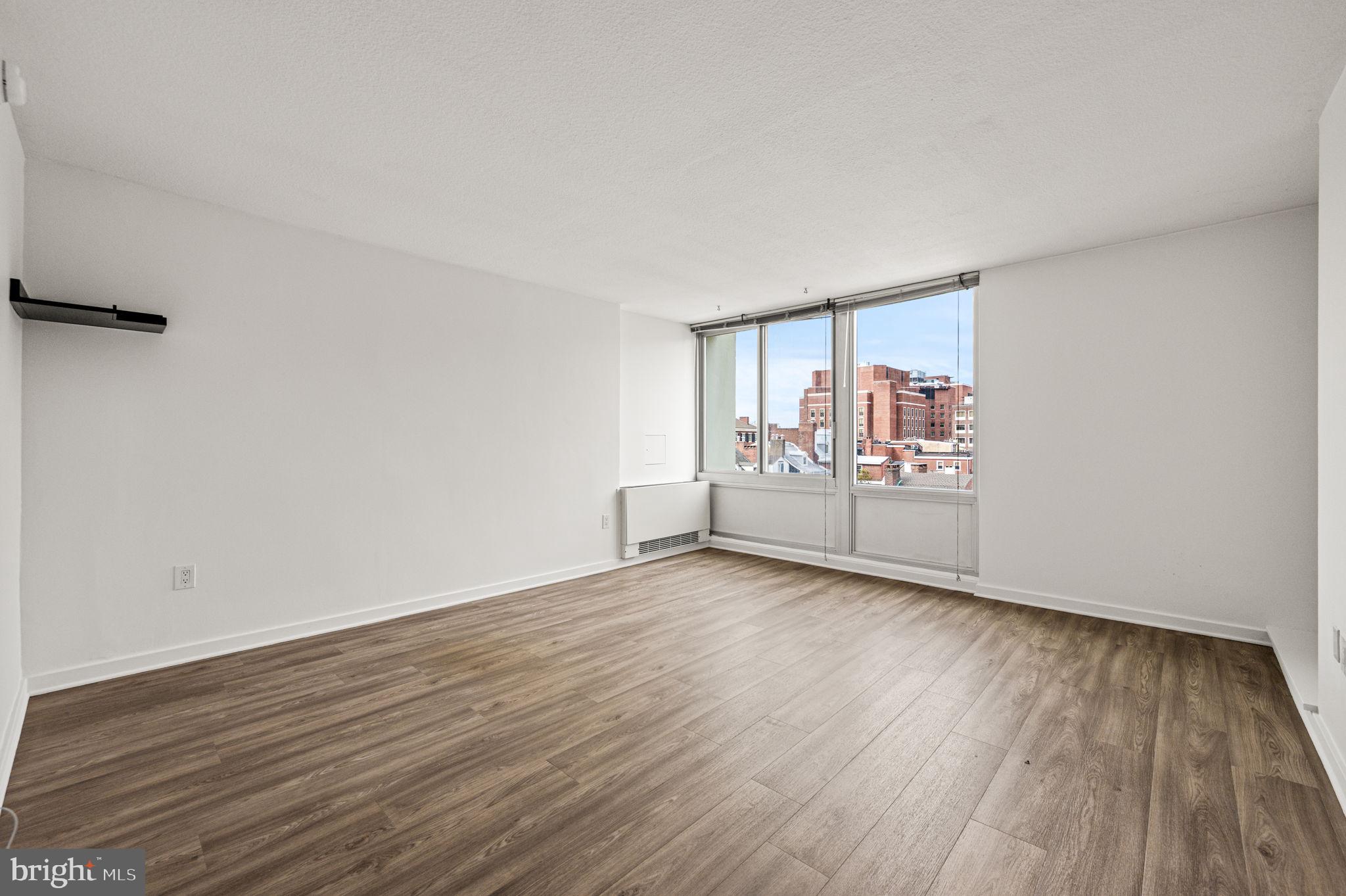 604 South Washington Square, Unit 418 Philadelphia, PA 19106 - Photo 2 of 22 a view of an empty room with wooden floor and a window