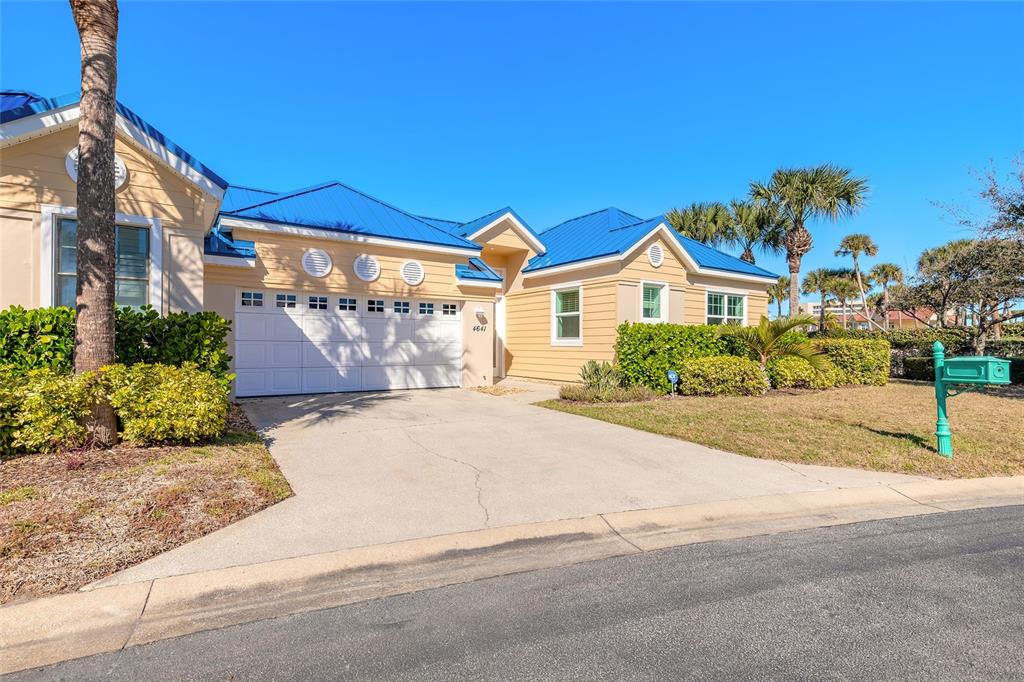 4641 Riverwalk Village Court Ponce Inlet, FL 32127 - Photo 2 of 74 a front view of a house with a yard and garage