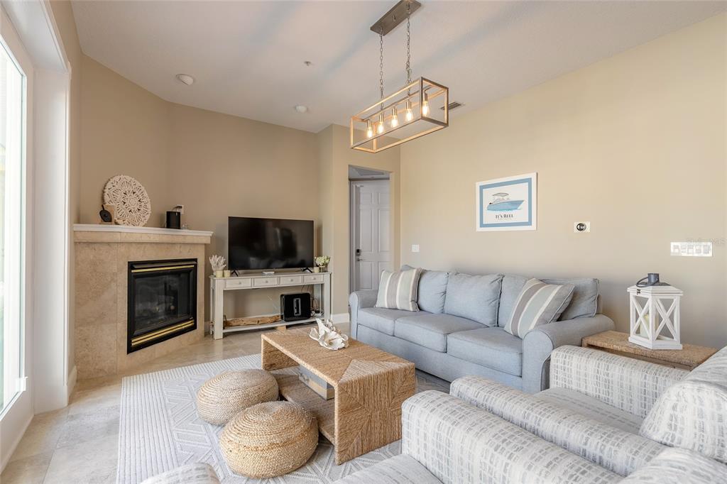 4641 Riverwalk Village Court Ponce Inlet, FL 32127 - Photo 41 of 74 a living room with furniture a flat screen tv and a fireplace