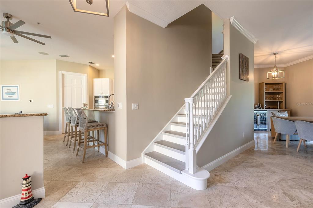 4641 Riverwalk Village Court Ponce Inlet, FL 32127 - Photo 43 of 74 a view of a hallway with dining room and stairs