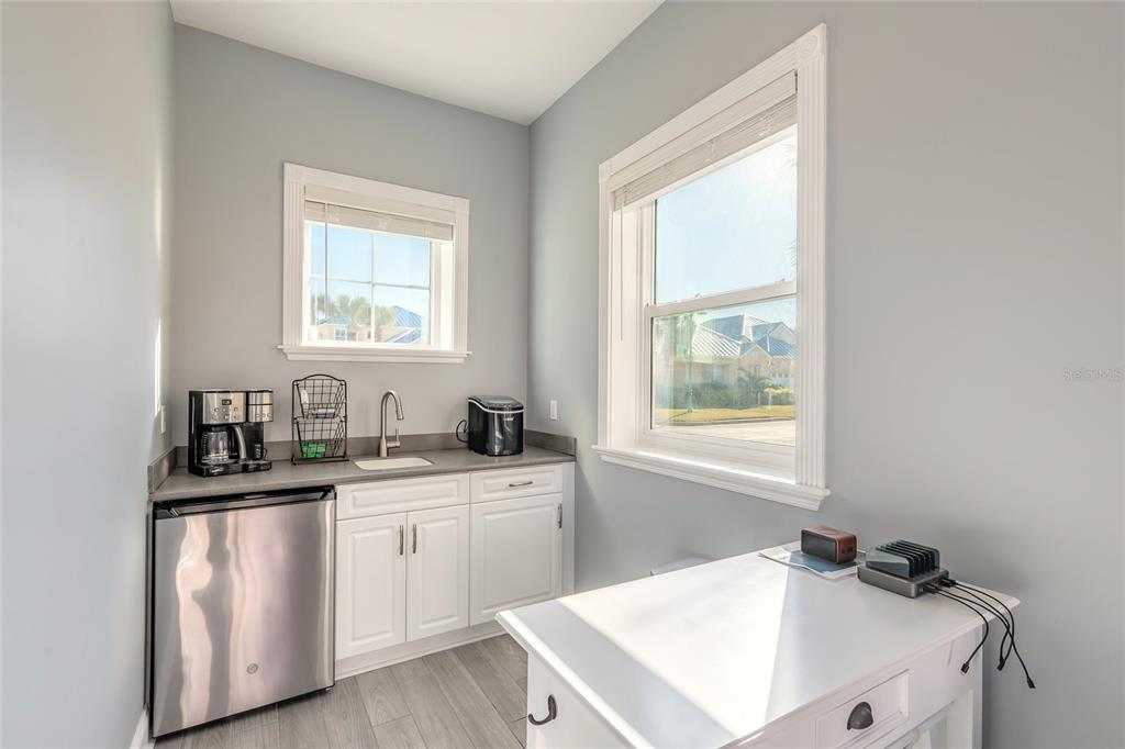 4641 Riverwalk Village Court Ponce Inlet, FL 32127 - Photo 58 of 74 a kitchen with a sink cabinets appliances and a window