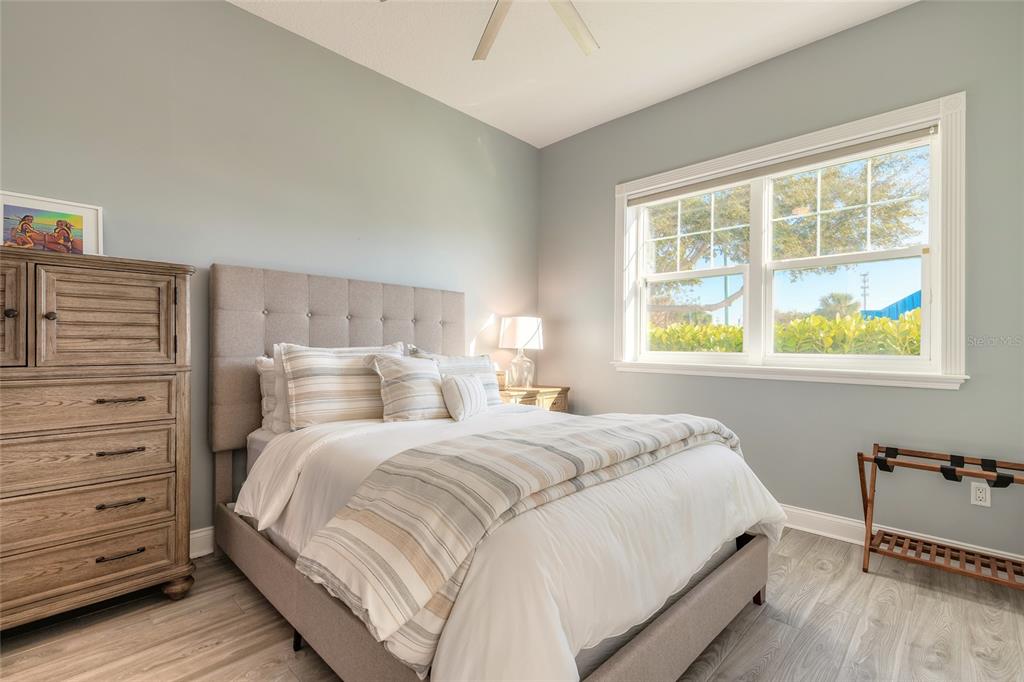 4641 Riverwalk Village Court Ponce Inlet, FL 32127 - Photo 60 of 74 a bedroom with a bed and a window