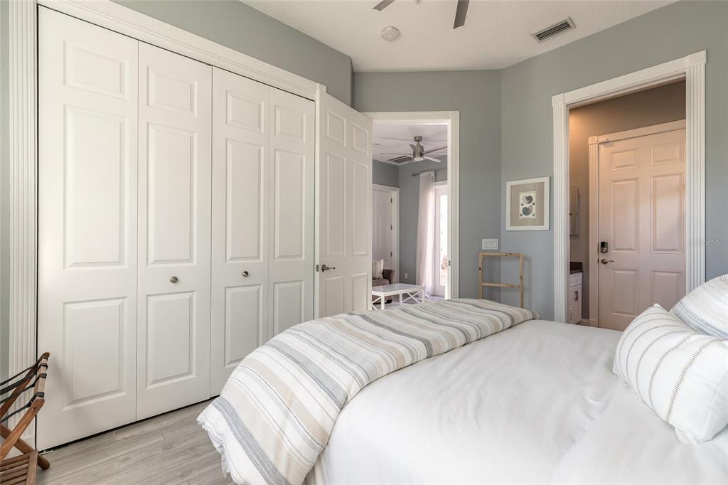 4641 Riverwalk Village Court Ponce Inlet, FL 32127 - Photo 61 of 74 a bedroom with a bed and a mirror