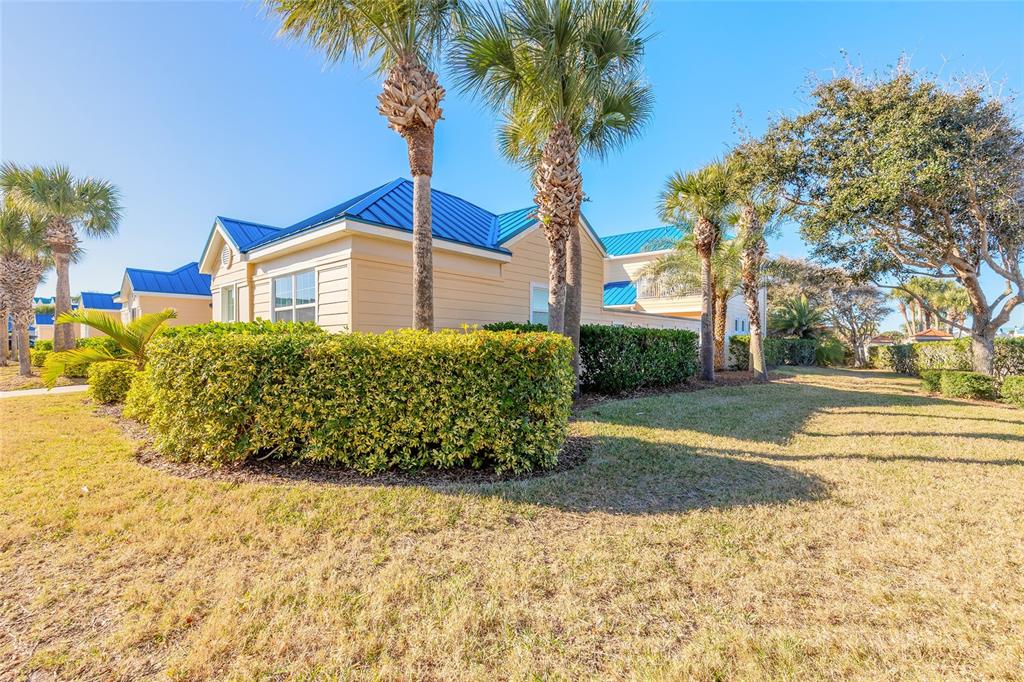 4641 Riverwalk Village Court Ponce Inlet, FL 32127 - Photo 64 of 74 a front view of a house with a yard and garage