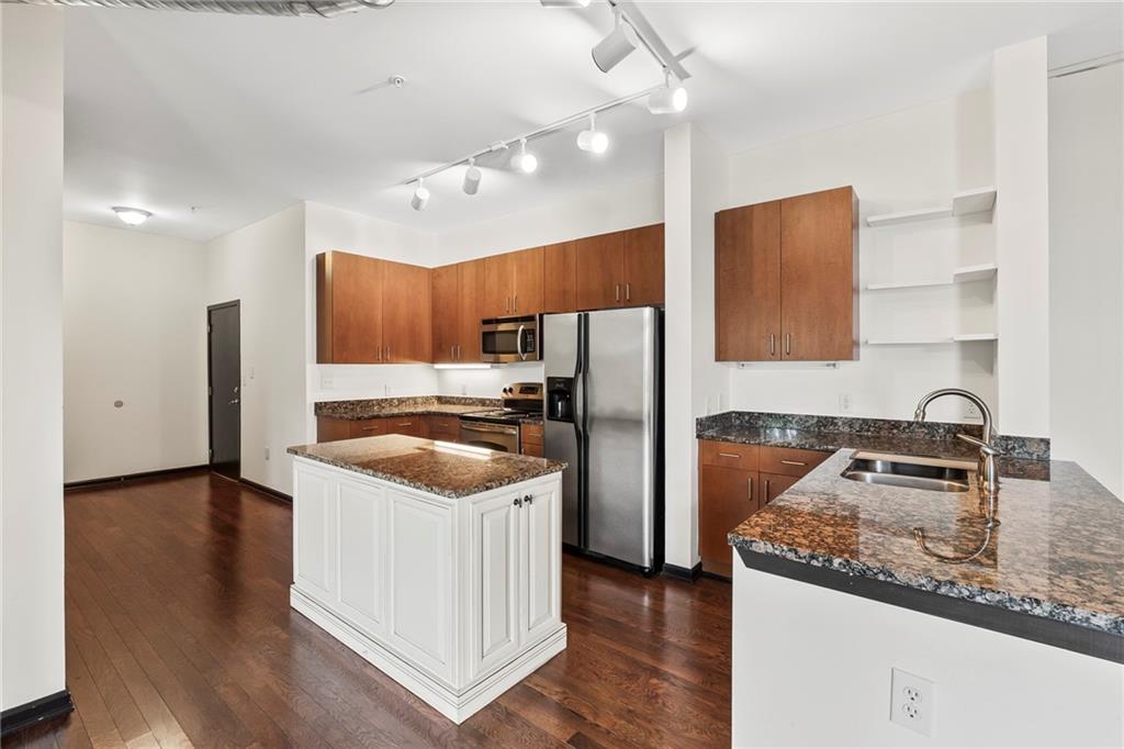 5300 Peachtree Road, Unit 2605 Chamblee, GA 30341 - Photo 4 of 26 a kitchen with stainless steel appliances granite countertop a sink stove and refrigerator
