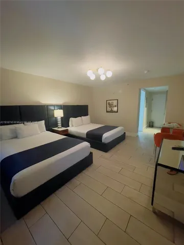 a bedroom with double bed and a couch