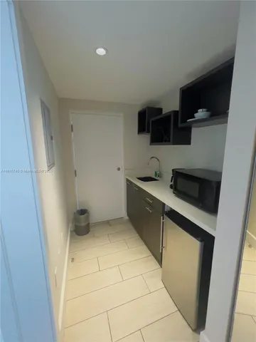 a kitchen with stainless steel appliances a refrigerator and a sink