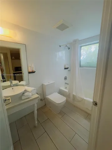 a bathroom with a sink toilet and mirror
