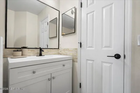 a bathroom with a double vanity sink and mirror