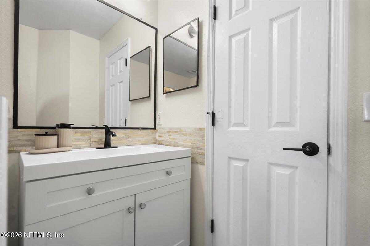 10310 Woodley Point Road Jacksonville, FL 32218 - Photo 17 of 30 a bathroom with a double vanity sink and mirror