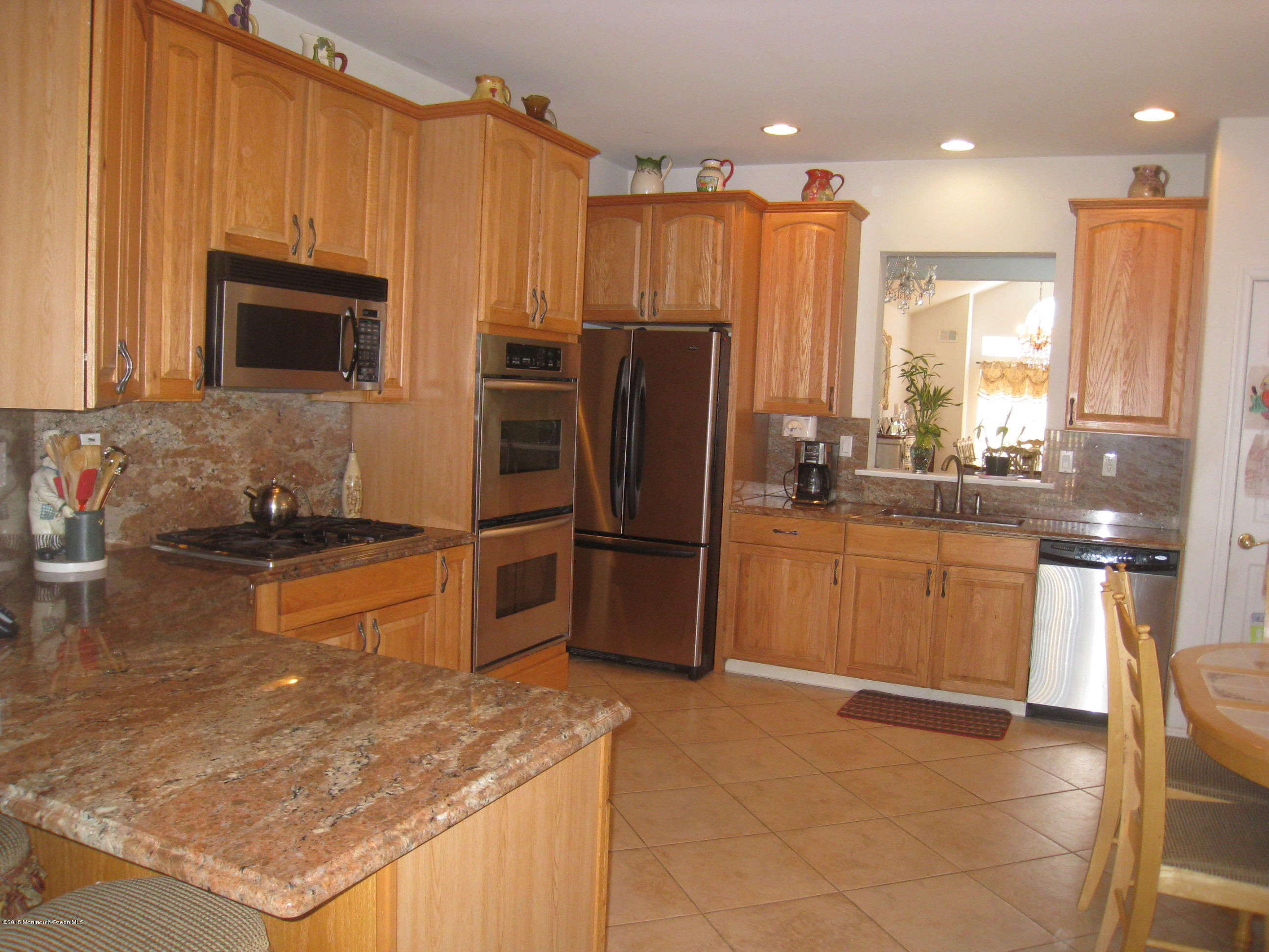 4 Ravello Road Manchester Township, NJ 08759 - Photo 3 of 27 a kitchen with stainless steel appliances granite countertop a refrigerator a stove a sink and a microwave