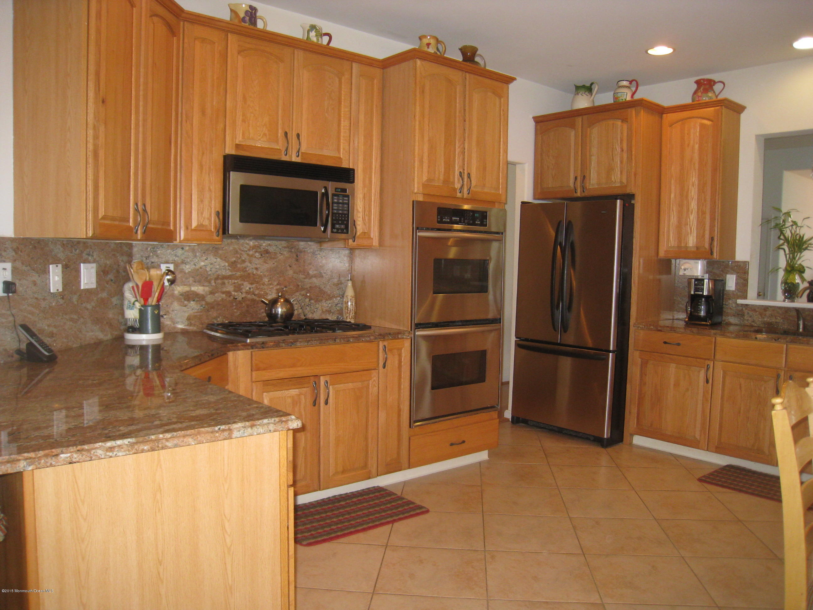 4 Ravello Road Manchester Township, NJ 08759 - Photo 4 of 27 a kitchen with stainless steel appliances granite countertop a refrigerator and a sink