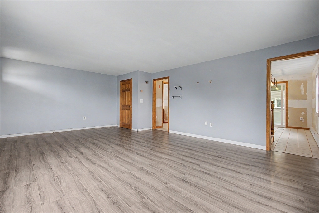 19 R Brian Avenue Derry, NH 03038 - Photo 17 of 37 a view of an empty room with wooden floor and a window