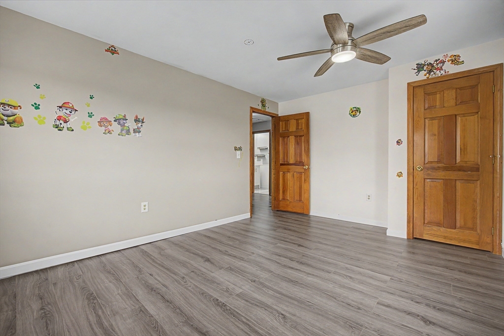 19 R Brian Avenue Derry, NH 03038 - Photo 24 of 37 an empty room with wooden floor and ceiling fan