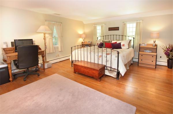 50 Towne Road Boxford, MA 01921 - Photo 16 of 30 a spacious bedroom with a bed a dresser with wooden floor