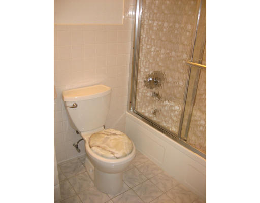 154 Lake Shore Road, Unit 3 Boston, MA 02135 - Photo 7 of 14 a white toilet sitting next to a bathroom sink