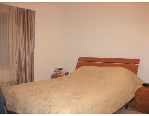 154 Lake Shore Road, Unit 3 Boston, MA 02135 - Photo 8 of 14 a bedroom with a bed and curtain
