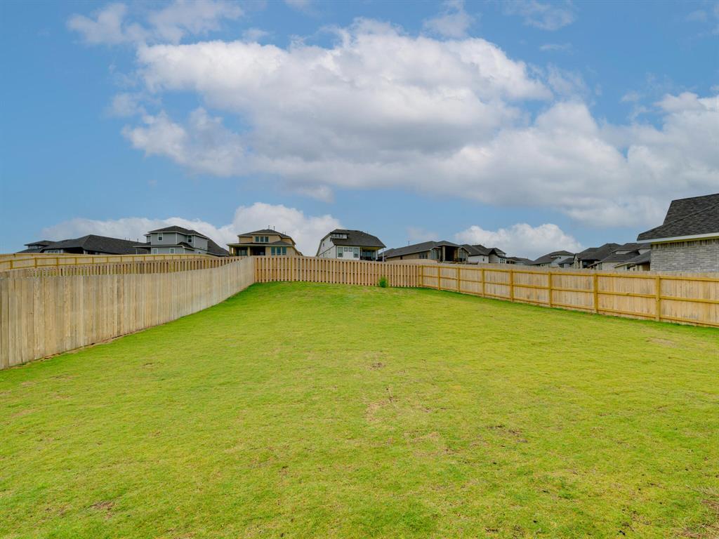 1208 Sweetspire Street Leander, TX 78641 - Photo 28 of 36 Expansive backyard featuring a manicured lawn and a newly installed wood privacy fence