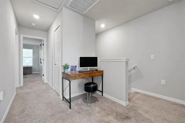 a spacious bedroom with a bed and a ceiling fan