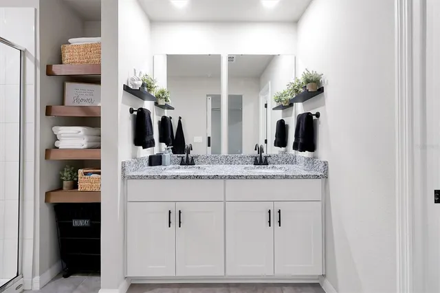 a bathroom with a double vanity sink and a mirror
