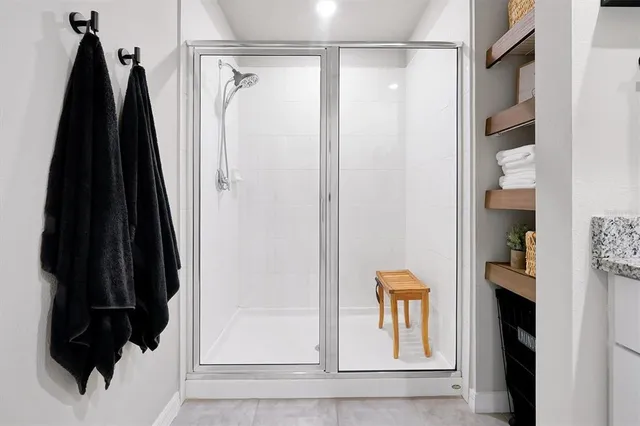 a bathroom with a granite countertop sink a toilet and a mirror