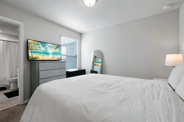 a large white bed in a white room