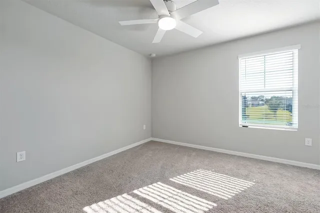 a bedroom with a bed and a potted plant