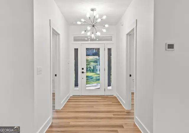 a view of empty room with window and ceiling fan