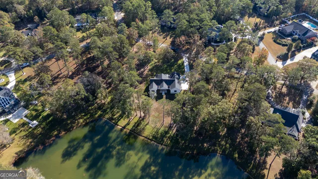 a kitchen with a sink a microwave a refrigerator and cabinets