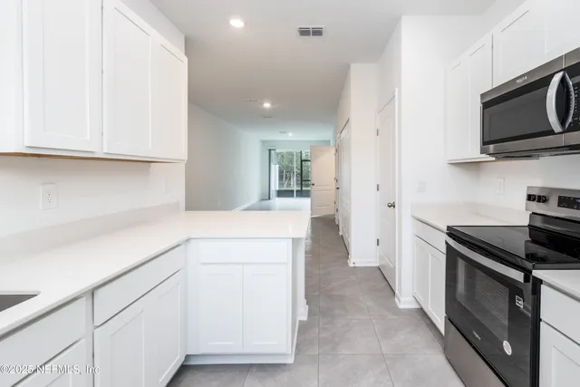 an empty room with large windows