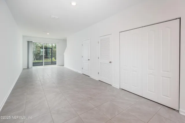 a view of a big room with closet and windows