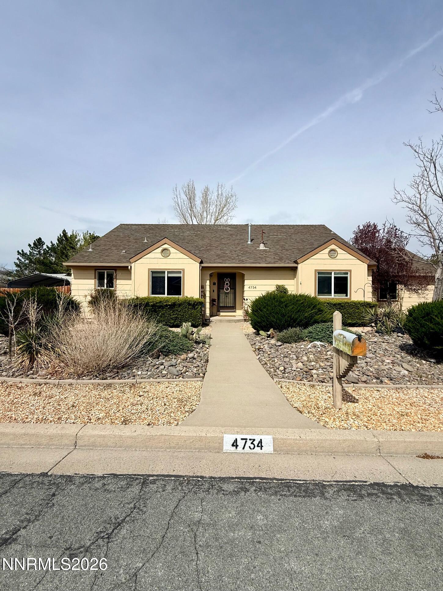 4734 Killdeer Road Carson City, NV 89701 - Photo 2 of 40 a view of a house with a snow in the background