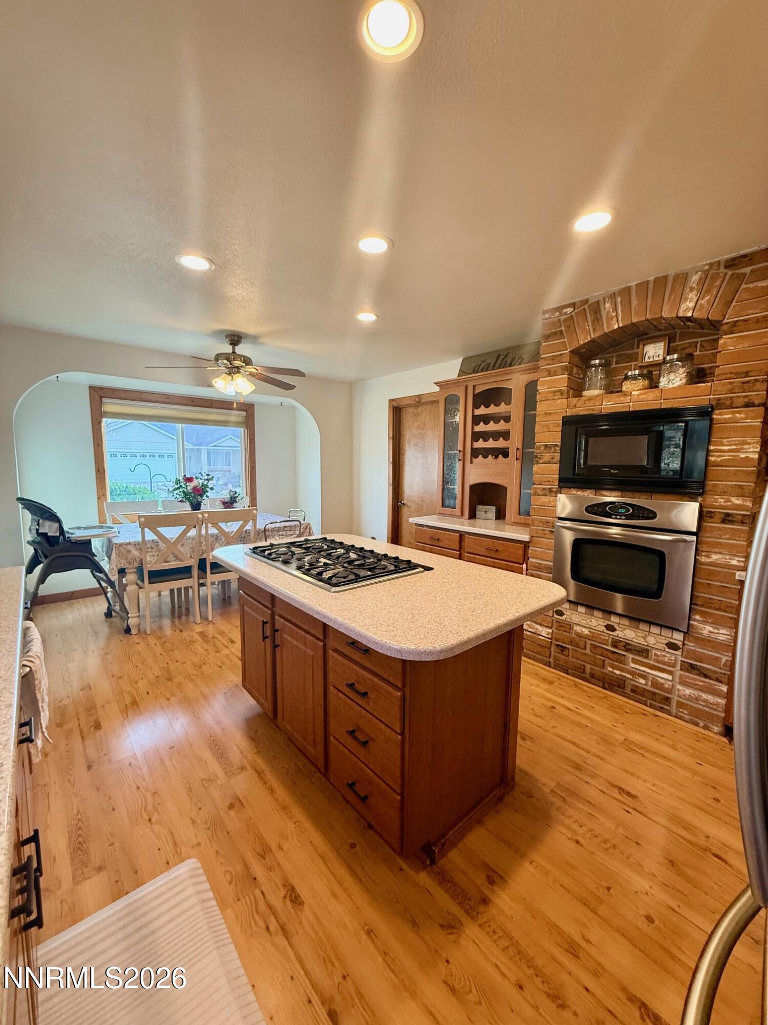 4734 Killdeer Road Carson City, NV 89701 - Photo 22 of 40 a large kitchen with stainless steel appliances granite countertop a stove and a wooden cabinets