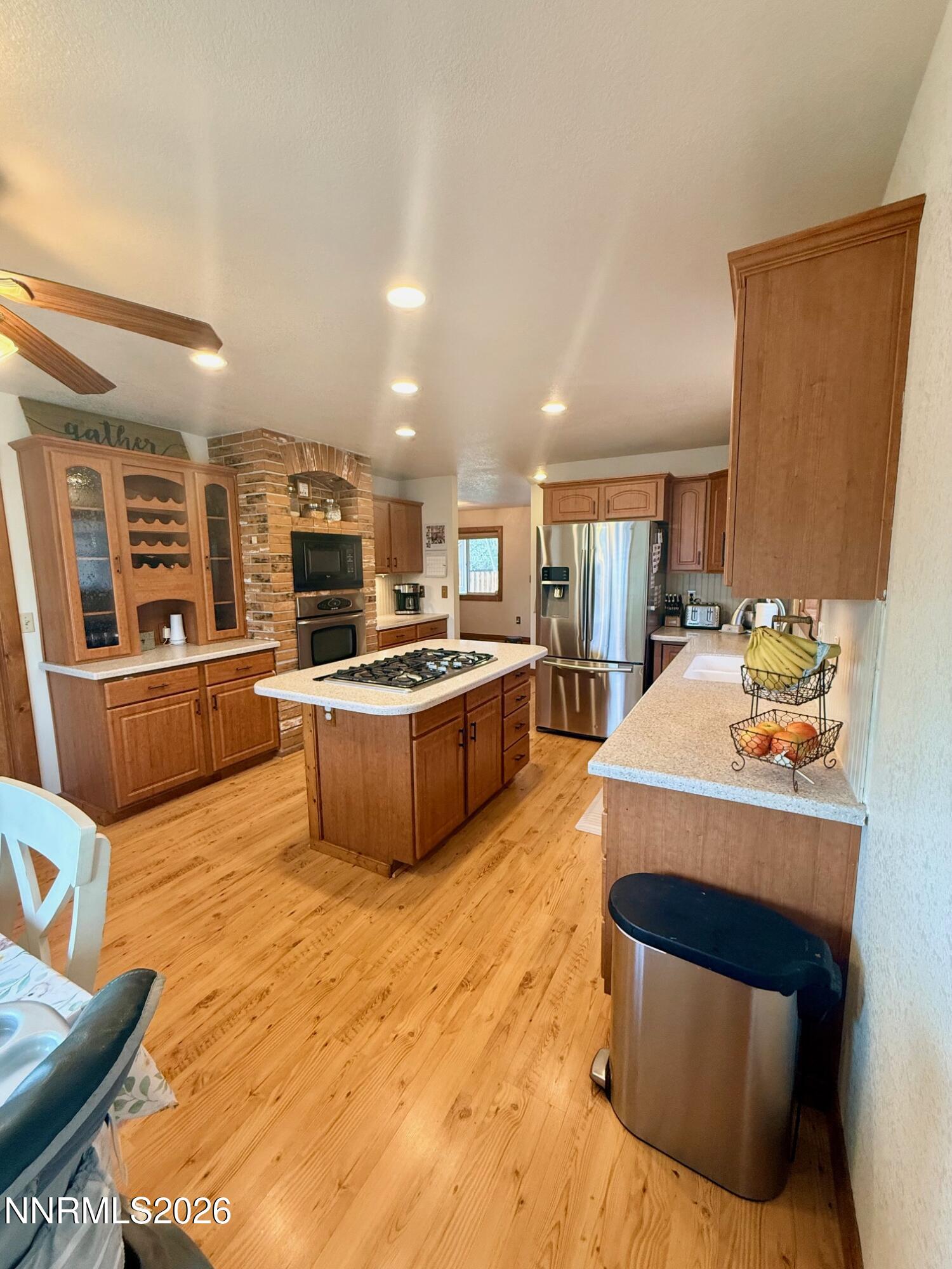 4734 Killdeer Road Carson City, NV 89701 - Photo 24 of 40 a kitchen with stainless steel appliances kitchen island granite countertop a sink and cabinets
