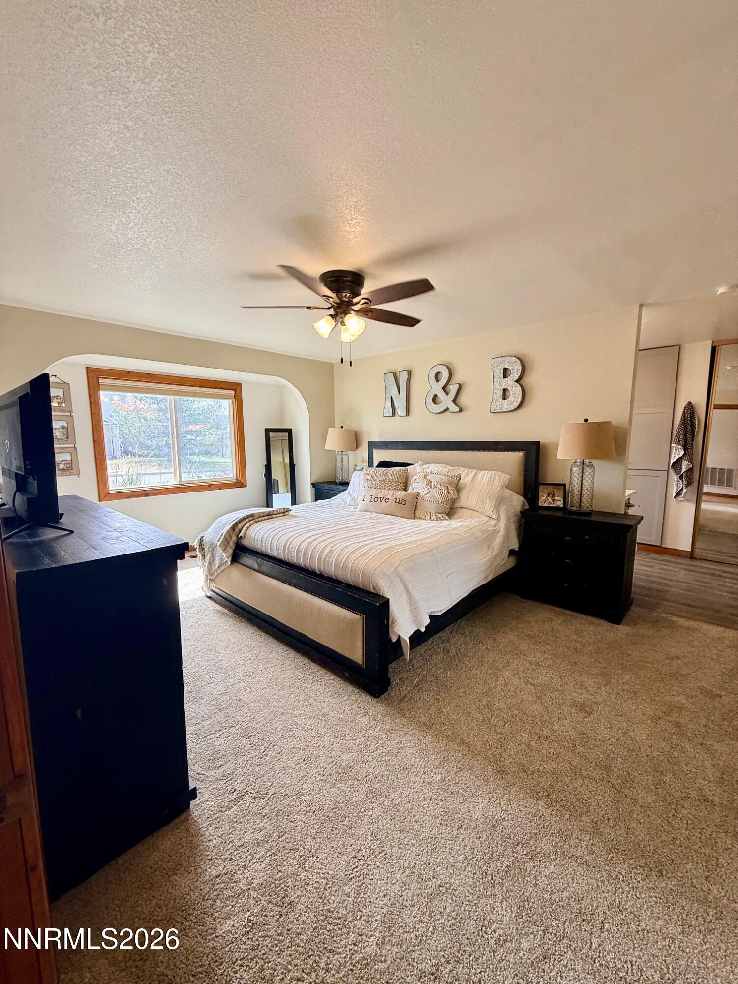 4734 Killdeer Road Carson City, NV 89701 - Photo 29 of 40 a spacious bedroom with a bed and window