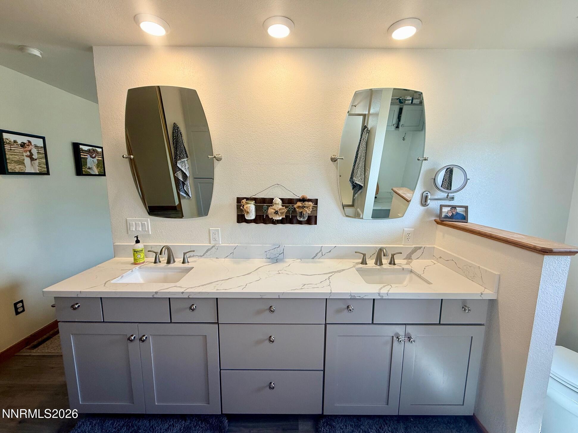 4734 Killdeer Road Carson City, NV 89701 - Photo 32 of 40 a bathroom with a double vanity sink and a mirror